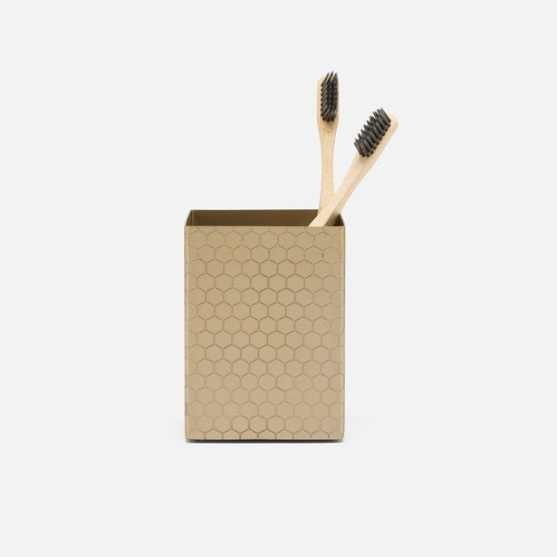 Pigeon & Poodle Temara brush holder in gold with honeycomb texture, holding two bamboo toothbrushes.
