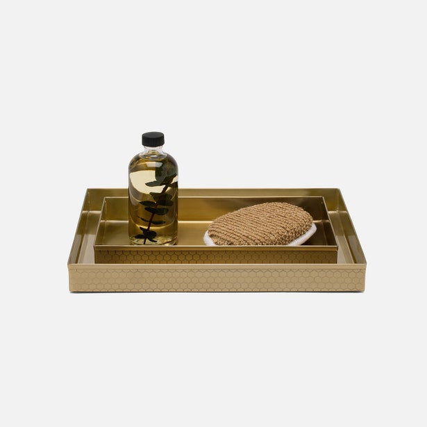 Pigeon & Poodle Temara nesting tray set in gold with geometric pattern, styled with bath accessories.
