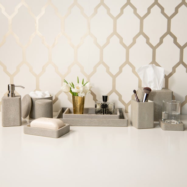 Pigeon & Poodle Tenby bath accessories set styled on white surface with geometric wallpaper.