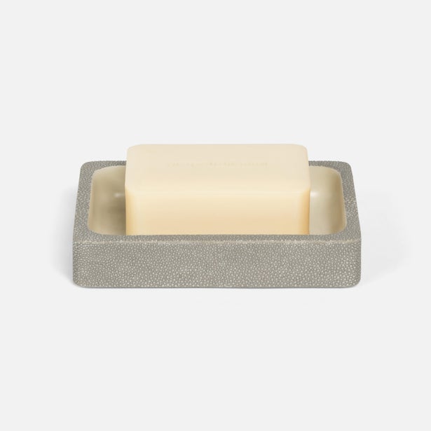 Ivory bar soap resting in a grey shagreen-textured rectangular soap dish.