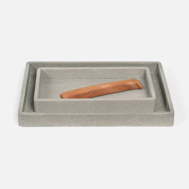 Two Pigeon & Poodle Tenby grey shagreen-textured nesting trays with a wooden comb styling prop.