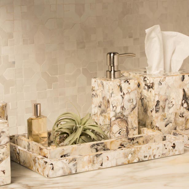 Tramore soap dish styled on tray with tissue box and soap dispenser in marbled stone finish.
