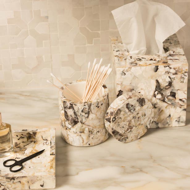 Tramore soap dish styled on marble counter alongside matching tissue box and cotton swab holder.