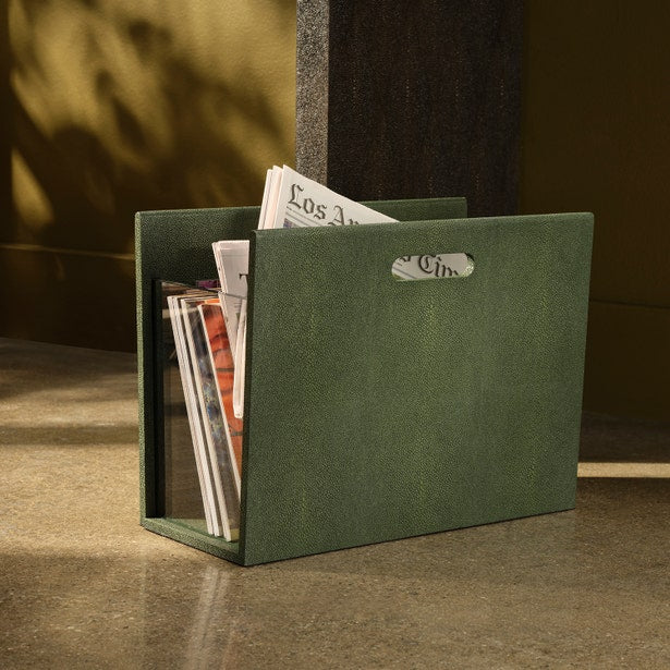 Pigeon & Poodle Turin magazine holder in forest green, filled with magazines, warm light setting.