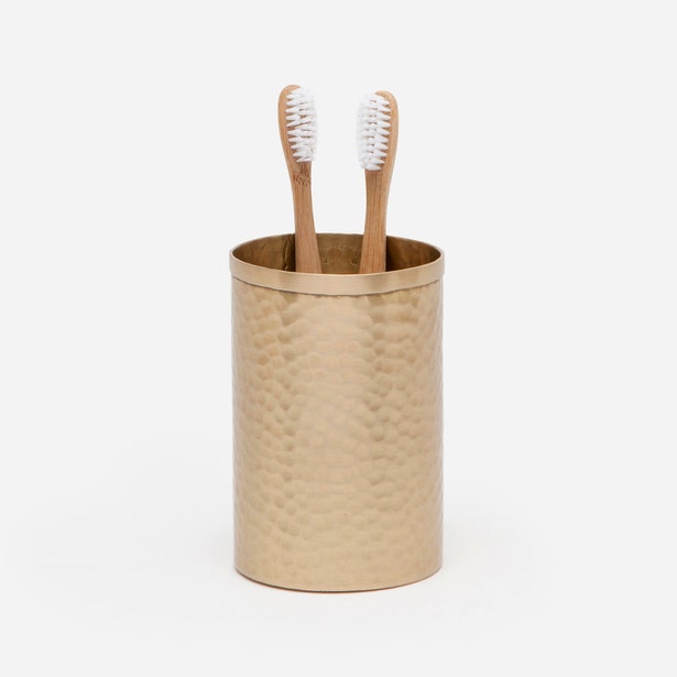 Pigeon & Poodle Verum brush holder in hammered brass with two bamboo toothbrushes.