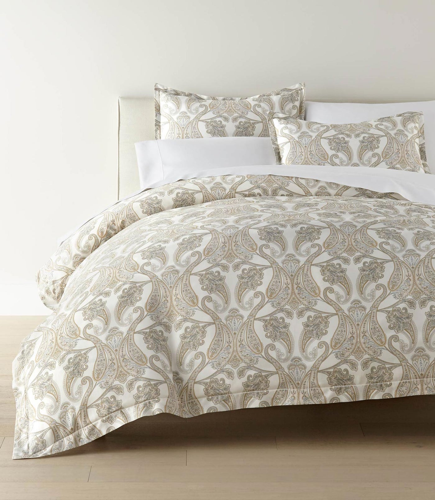 Peacock Alley Paisley Pearl duvet styled on bed, ivory with champagne damask motif.