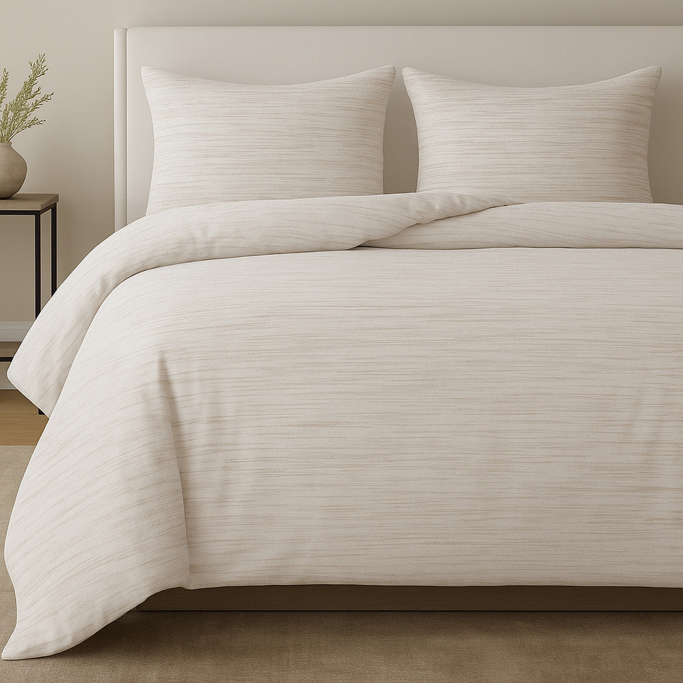 Ivory comforter set with subtle horizontal texture stripe detail, styled on a bed.