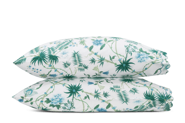 Matouk Palmyra pillowcase pair in white with teal and blue botanical print.