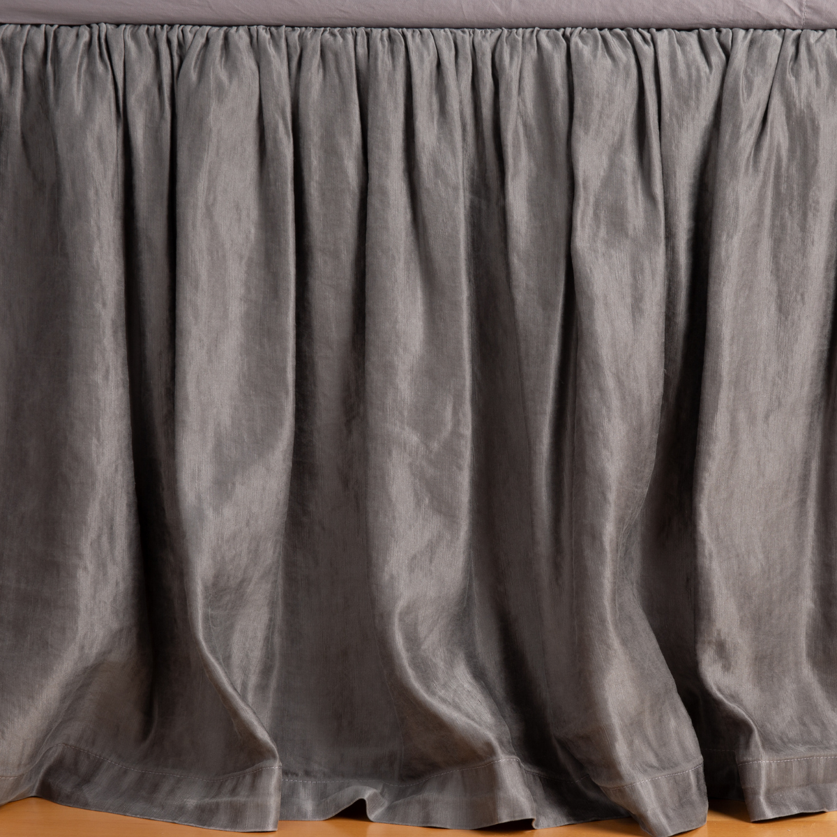 Gathered French Lavender linen bed skirt with soft draping, floor-length drop.