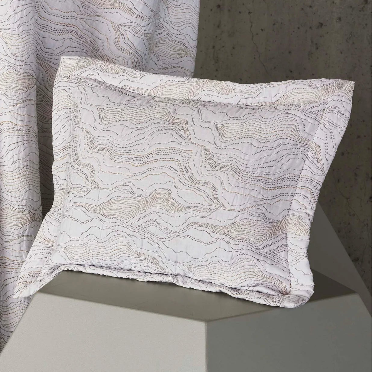 Celso de Lemos Perle ivory pillow sham with taupe wave-pattern embroidery and flange border.