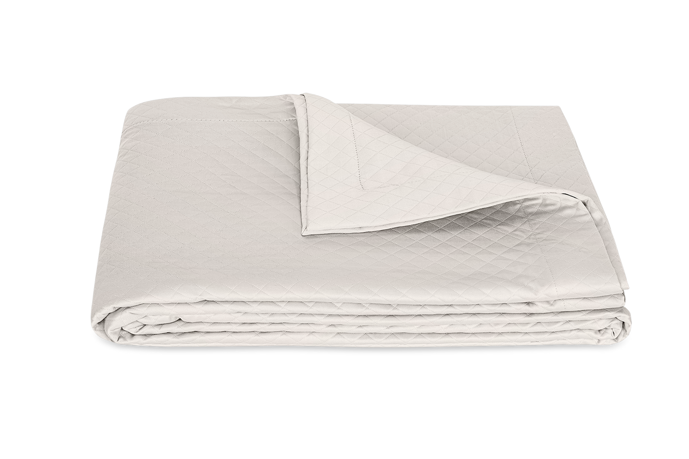 Matouk Petra coverlet folded, ivory quilted cotton with corner turned back.