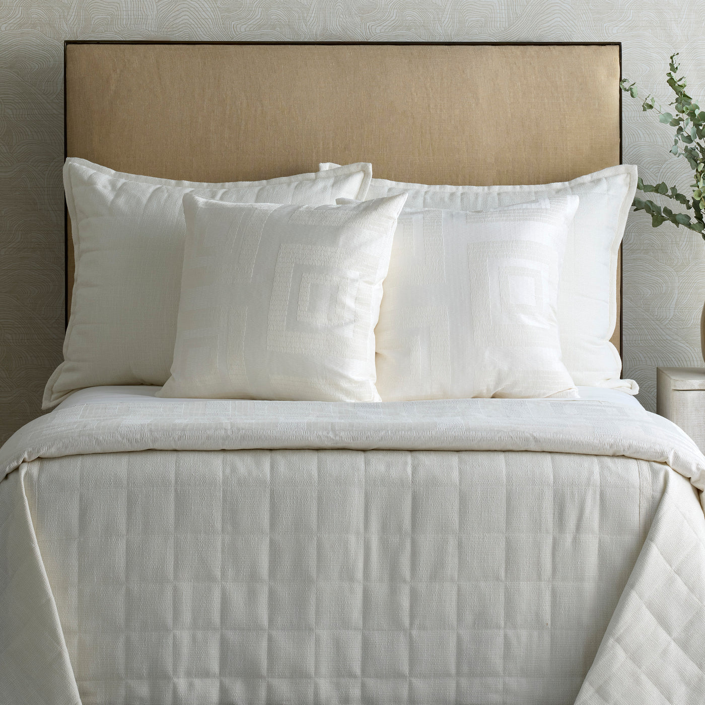 Ann Gish Piastrella duvet cover in ivory with geometric quilted pattern on styled bed.
