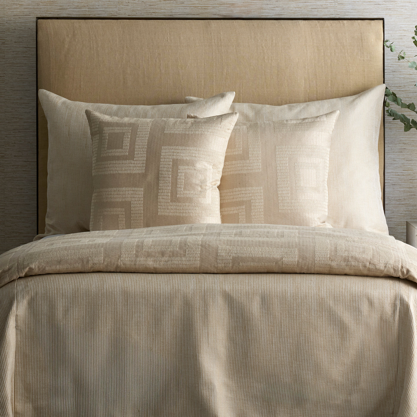 Ann Gish Piastrella duvet cover in ivory, styled on bed with geometric jacquard accent pillows.