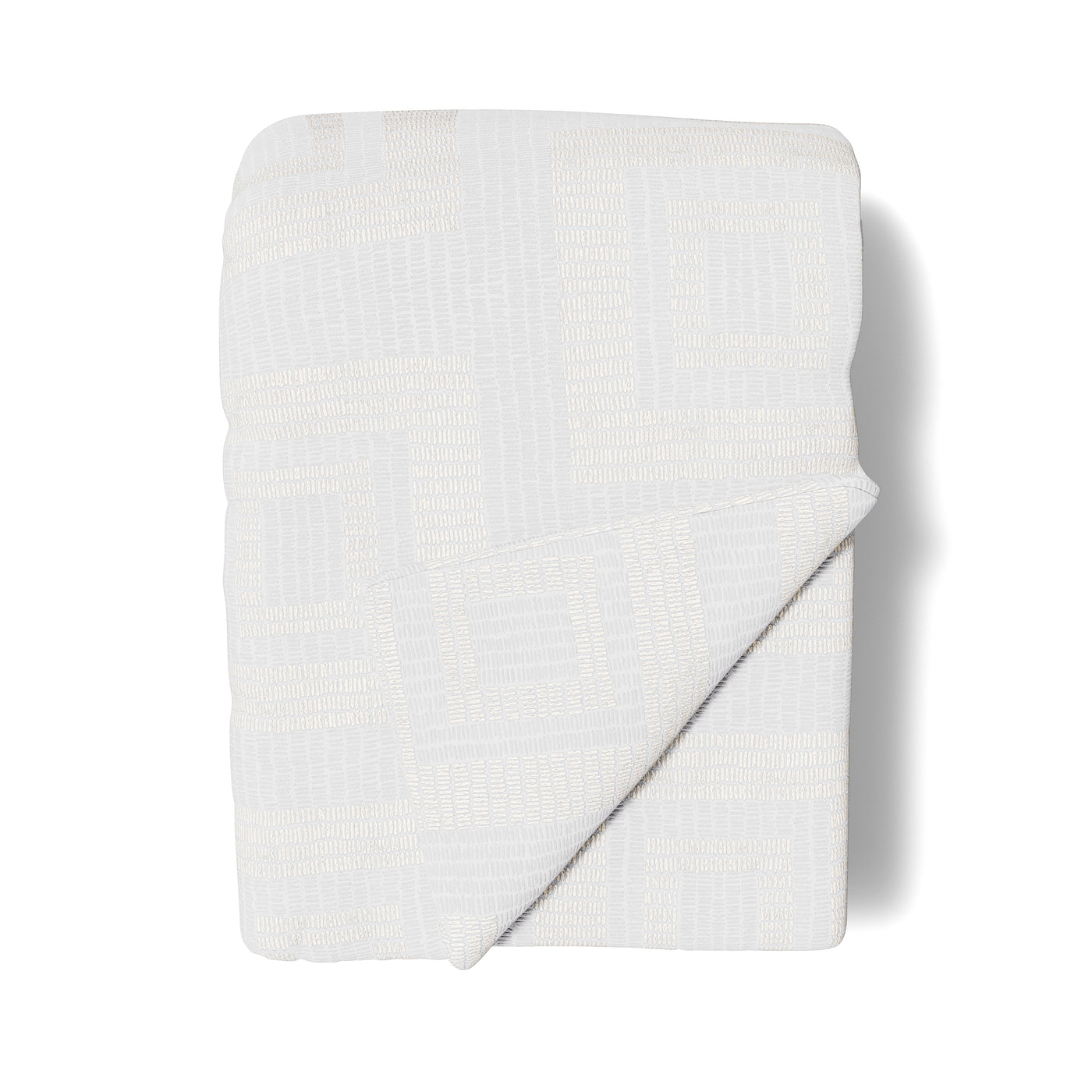 Close-up of Ann Gish Piastrella throw folded flat, ivory textured weave with subtle grid pattern.