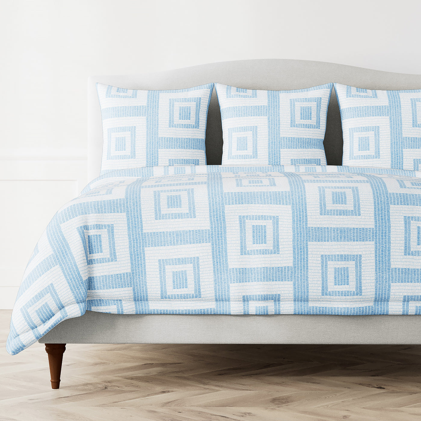Ann Gish Piastrella duvet cover in sky blue geometric square pattern on styled bed.