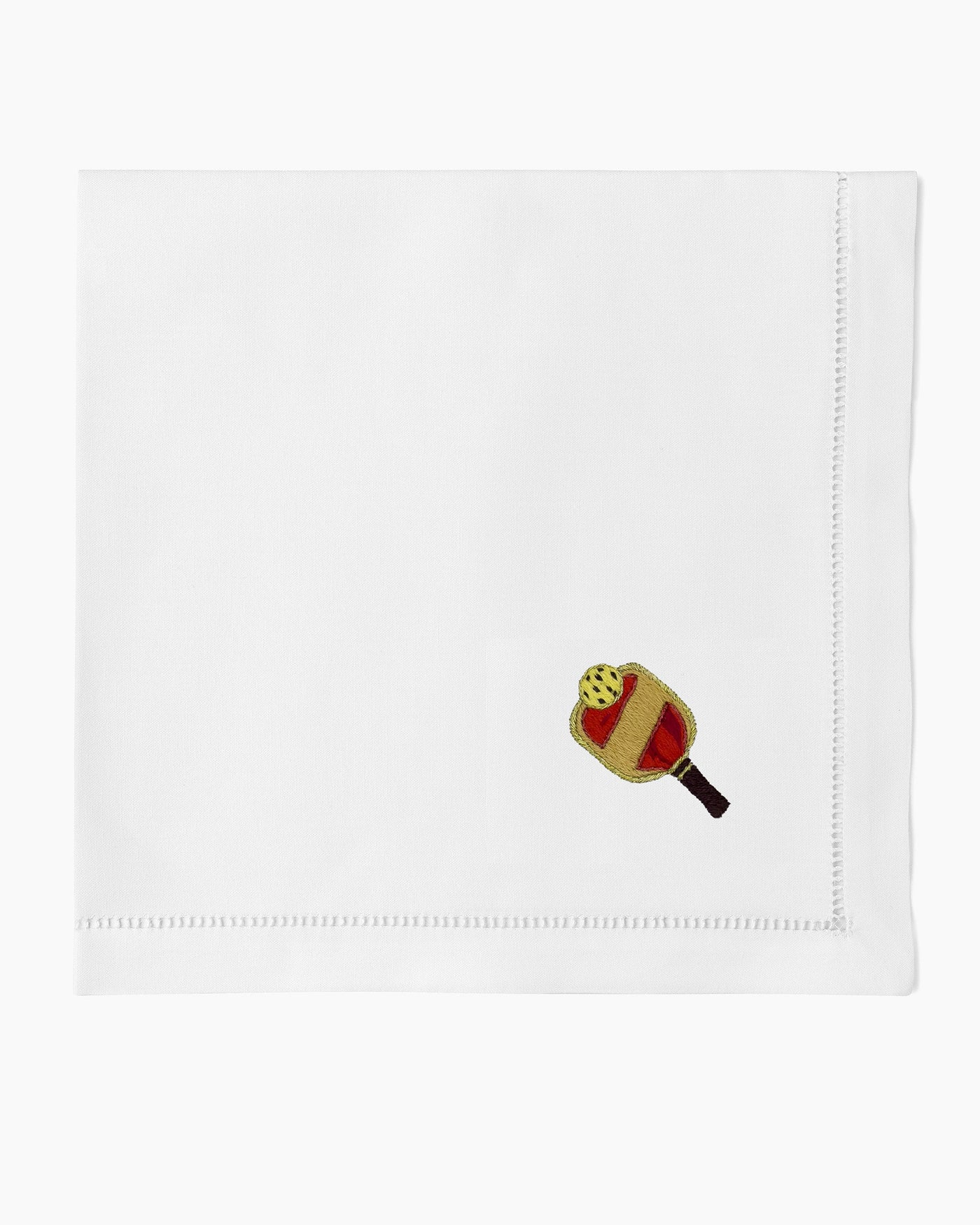 Henry Handwork white linen dinner napkin with embroidered pickleball paddle and ball.