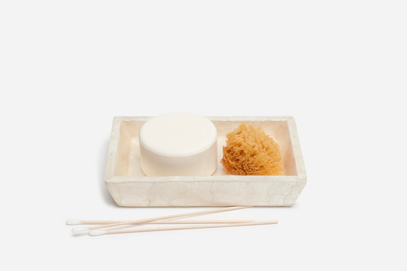 Pigeon & Poodle Andria soap dish in ivory holding soap, natural sponge, and cotton swabs.