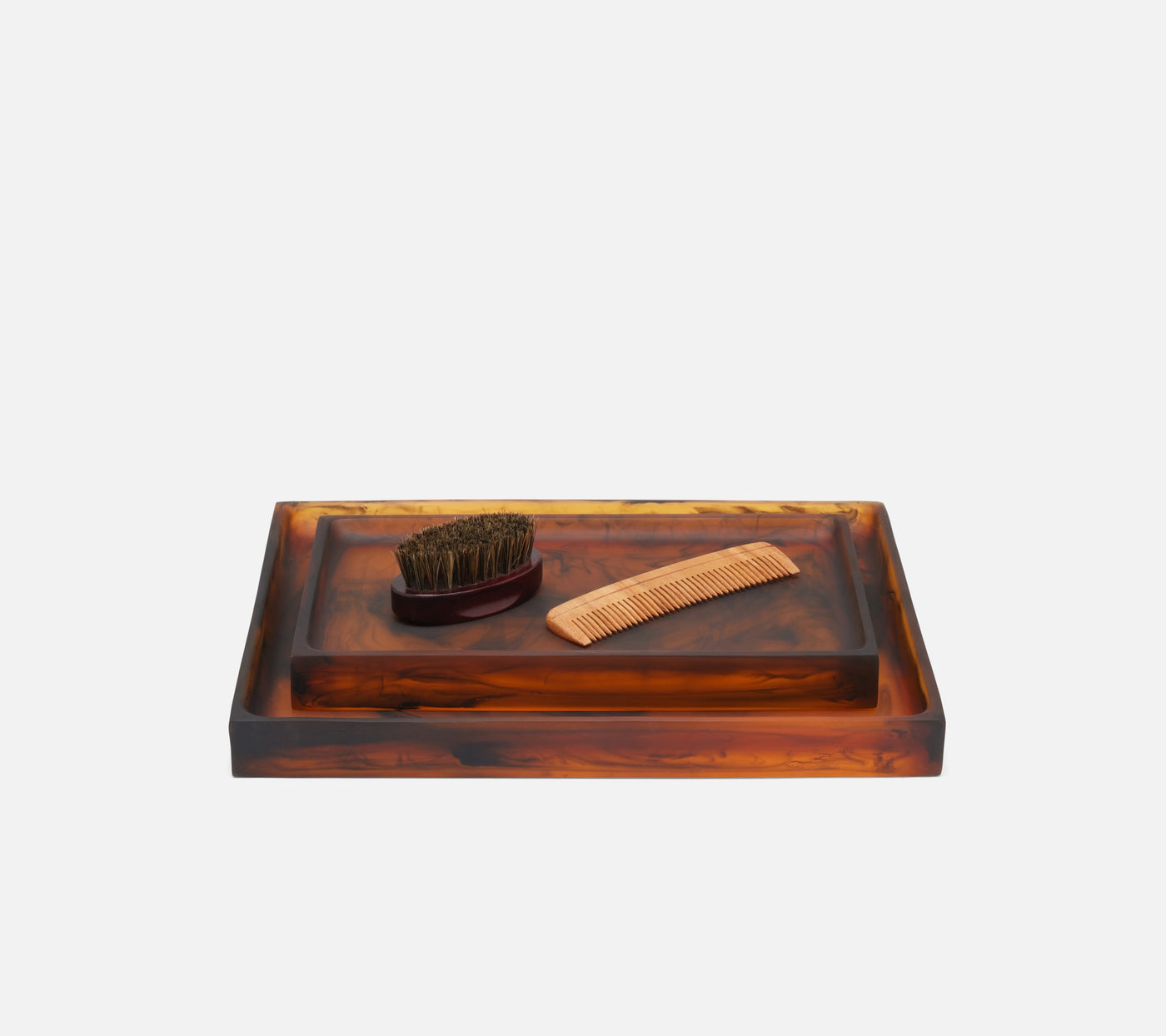 Pigeon & Poodle Tavira nesting tray set in tortoiseshell resin, styled with brush and comb.