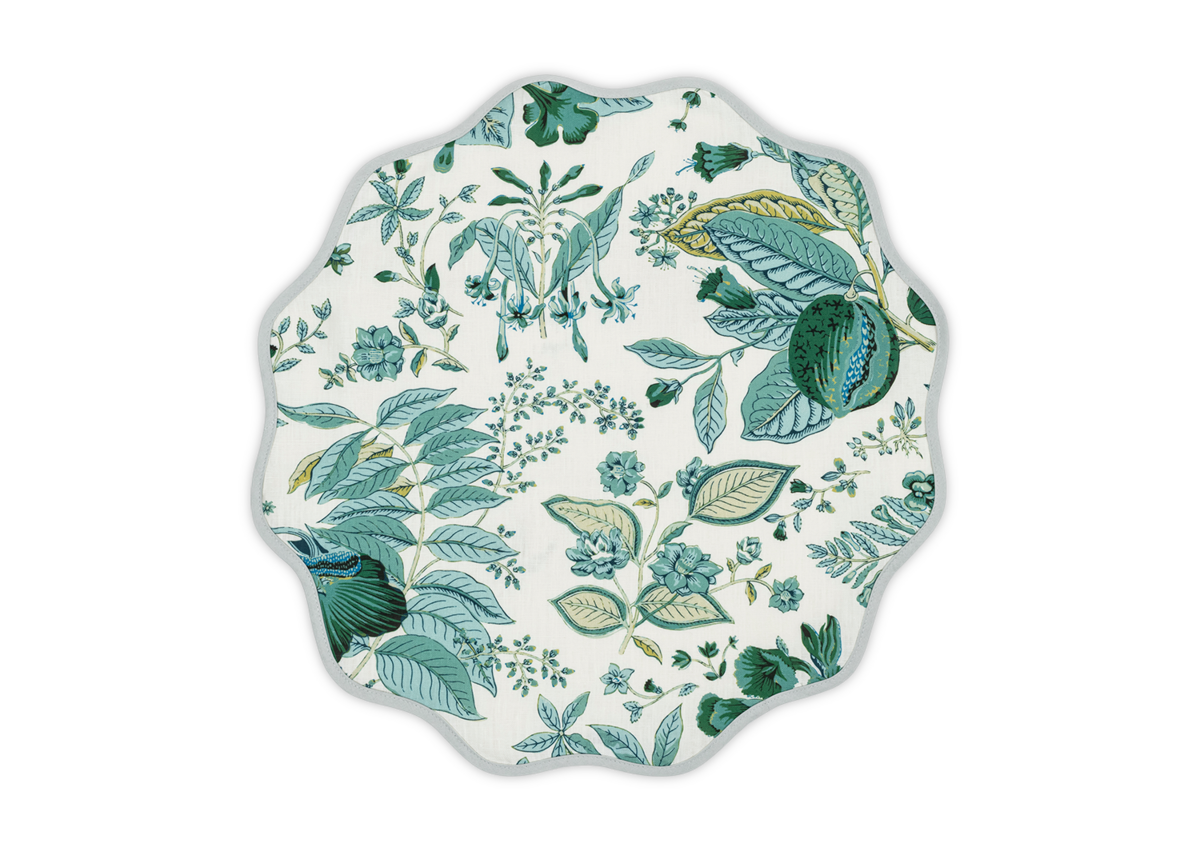 The Matouk Pomegranate Linen Placemat Set features a green and blue botanical floral pattern on white, ideal for pairing with your favorite table linens.