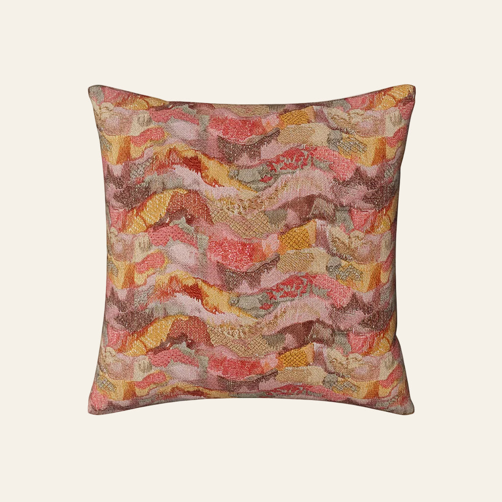 Ann Gish Positano pillow with coral, rose, and gold wave-patterned jacquard fabric.