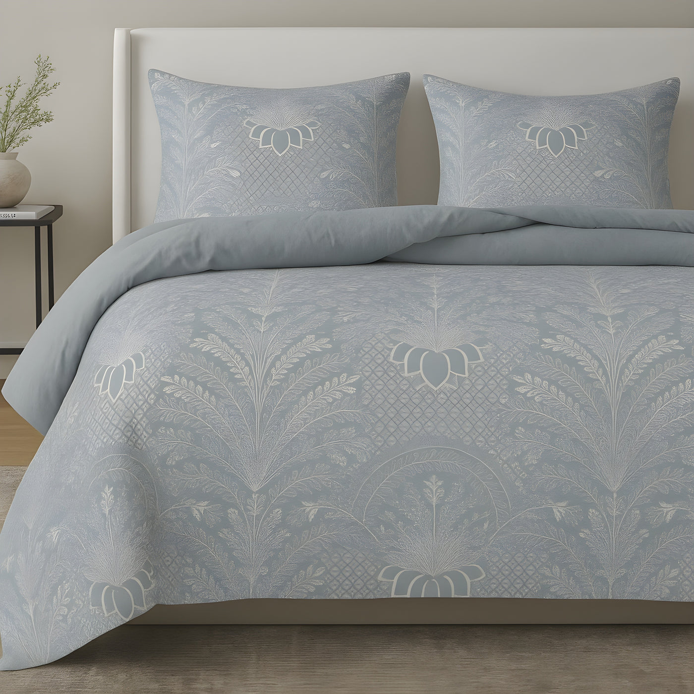 Ann Gish Printemps comforter set in pale blue with ivory botanical damask pattern, styled on bed.