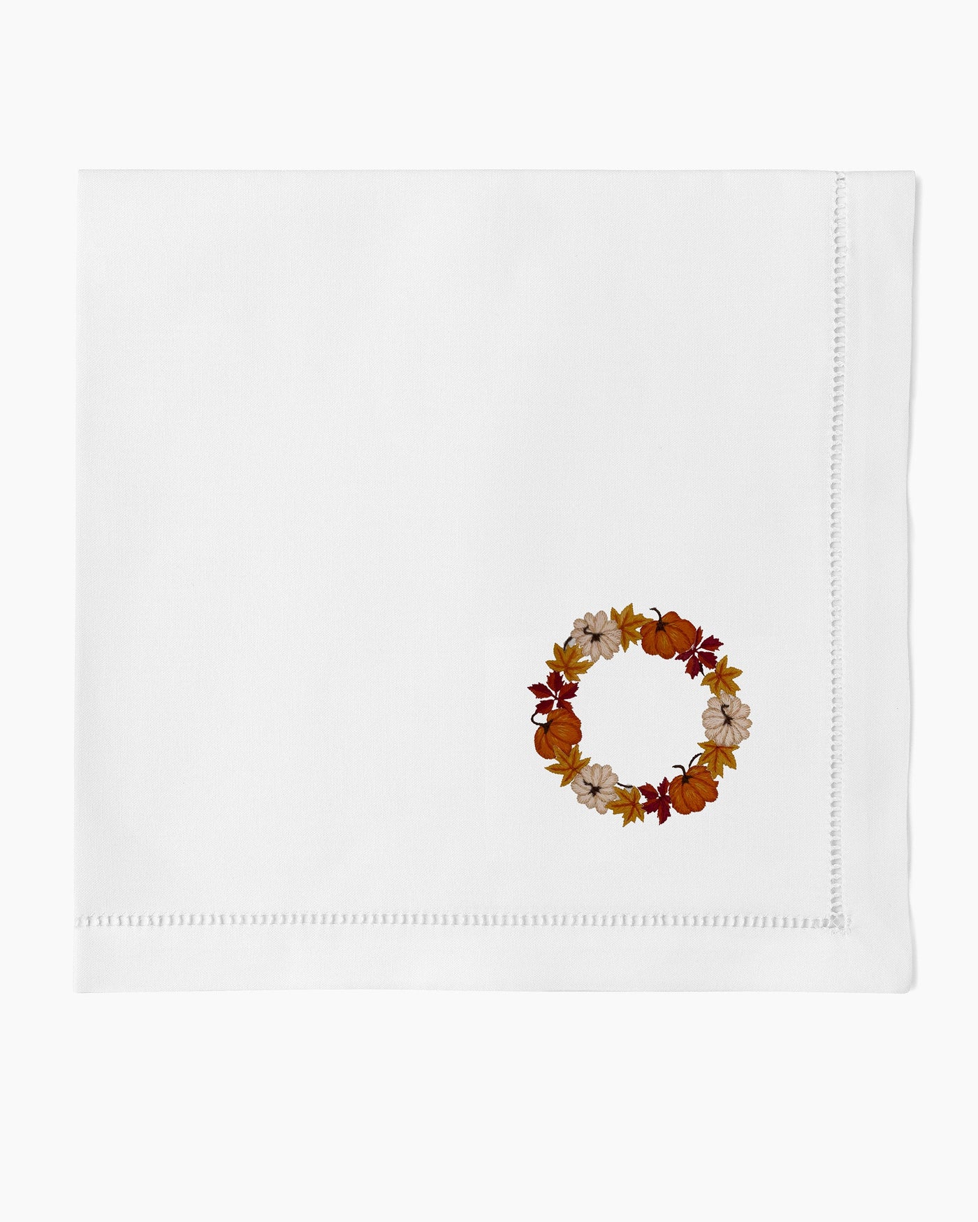 Henry Handwork white linen dinner napkin with embroidered autumn pumpkin wreath and hemstitch border.