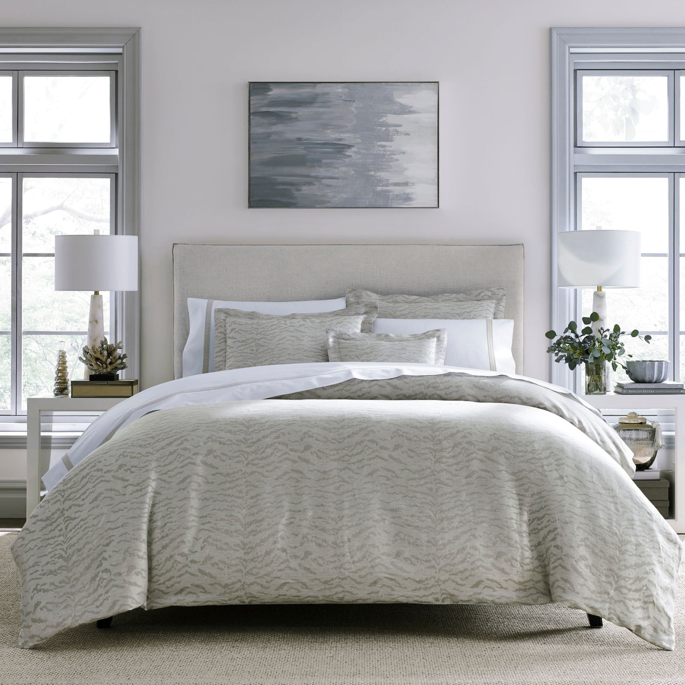 Alina pillowcase in ivory with subtle wave-textured jacquard, styled on a layered bed.