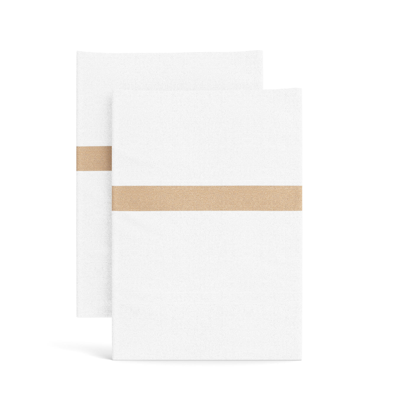 Close-up of two white cotton pillowcases with a champagne woven trim stripe accent.