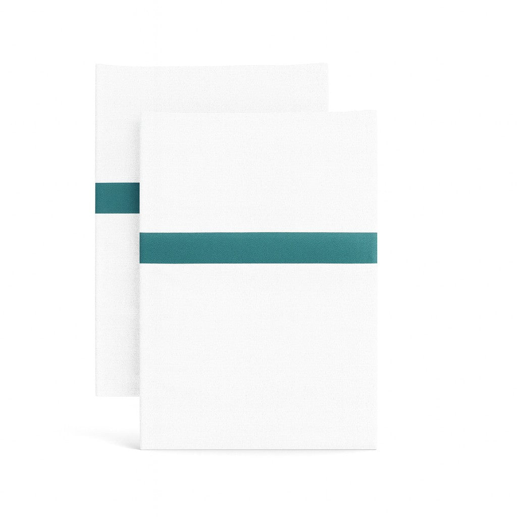 Ann Gish white pillowcases with teal trim stripe, folded pair on white background.