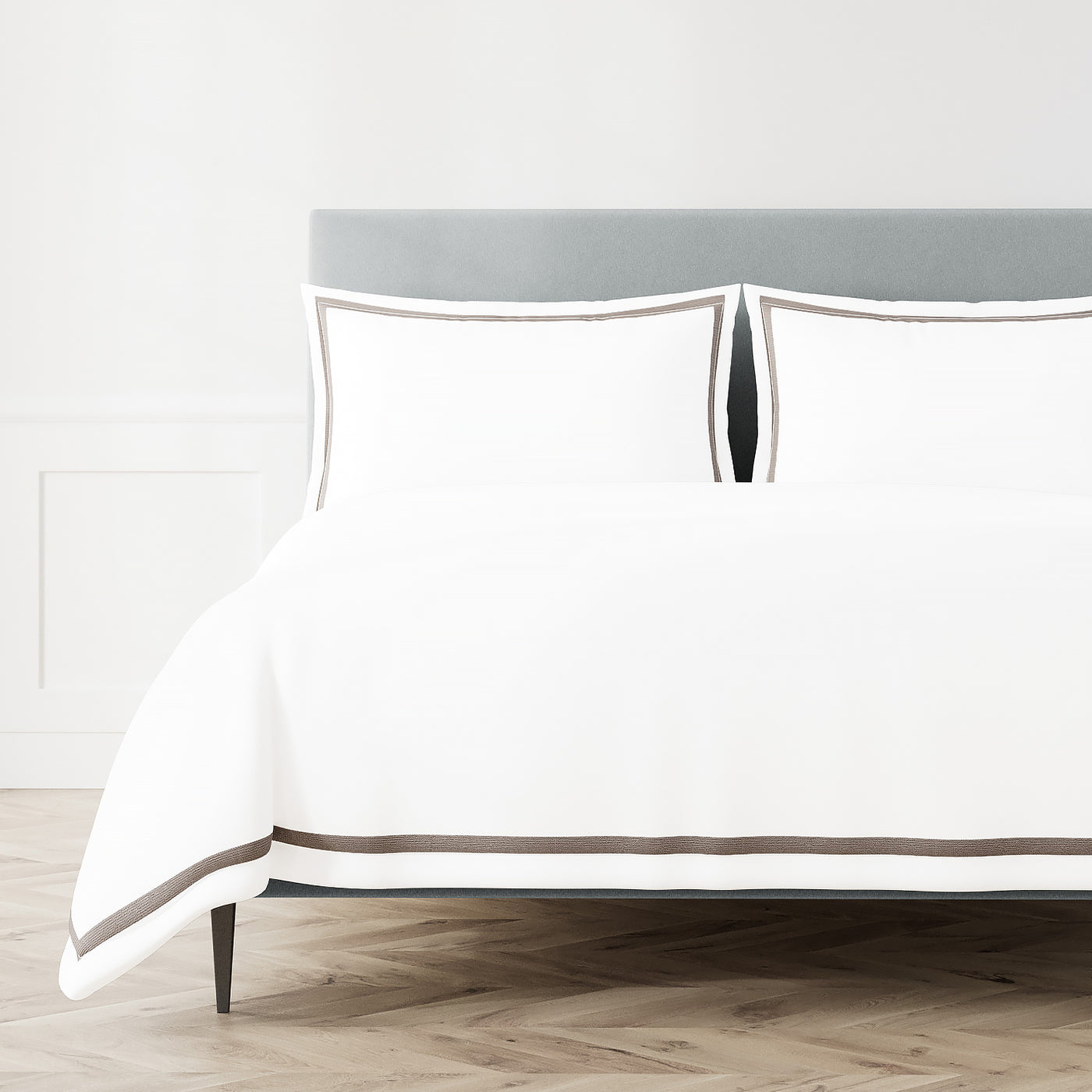 White Ann Gish duvet cover with chocolate double-stripe trim, styled on a bed with matching shams.