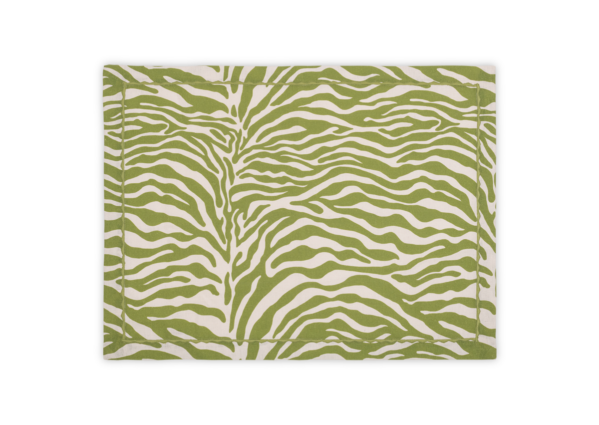 The Regine | Placemat Set by Matouk features a green and white stylized zebra motif on linen, part of the Schumacher collection, shown on a plain white background.