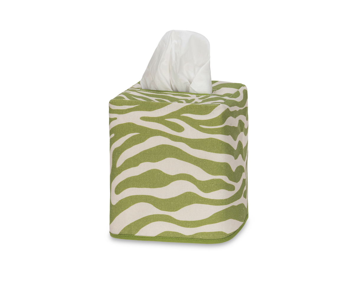 The Matouk Regine Linen Jacquard Tissue Box Cover features a green and white zebra design, crafted from decorative linen, with a tissue elegantly emerging from the top.