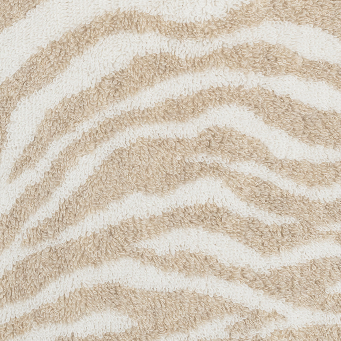 Close-up of the beige and white zebra motif on Matouk's Regine Guest Towel, crafted from a textured linen-cotton blend.