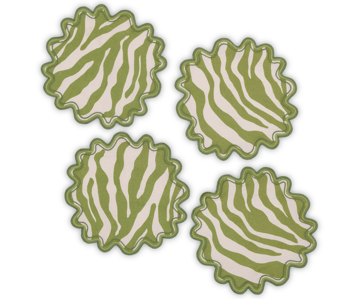 Four green and white round cocktail napkins with a stylized zebra motif and scalloped edges from Matouk’s Regine Collection, artfully arranged on a white background. These decorative linen napkins bring flair to any table setting.