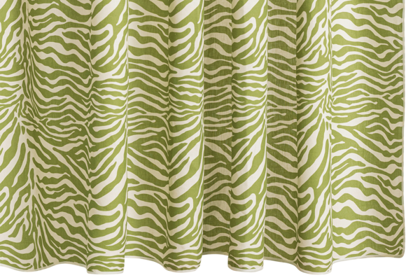 The Regine Linen Shower Curtain by Matouk features a green and white zebra motif, crafted from a linen-cotton blend with evenly spaced folds.