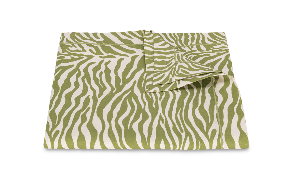 The Regine Tablecloth by Matouk features a folded green and white zebra motif, displayed on a plain white background—ideal as decorative printed linen for a stylish table setting.