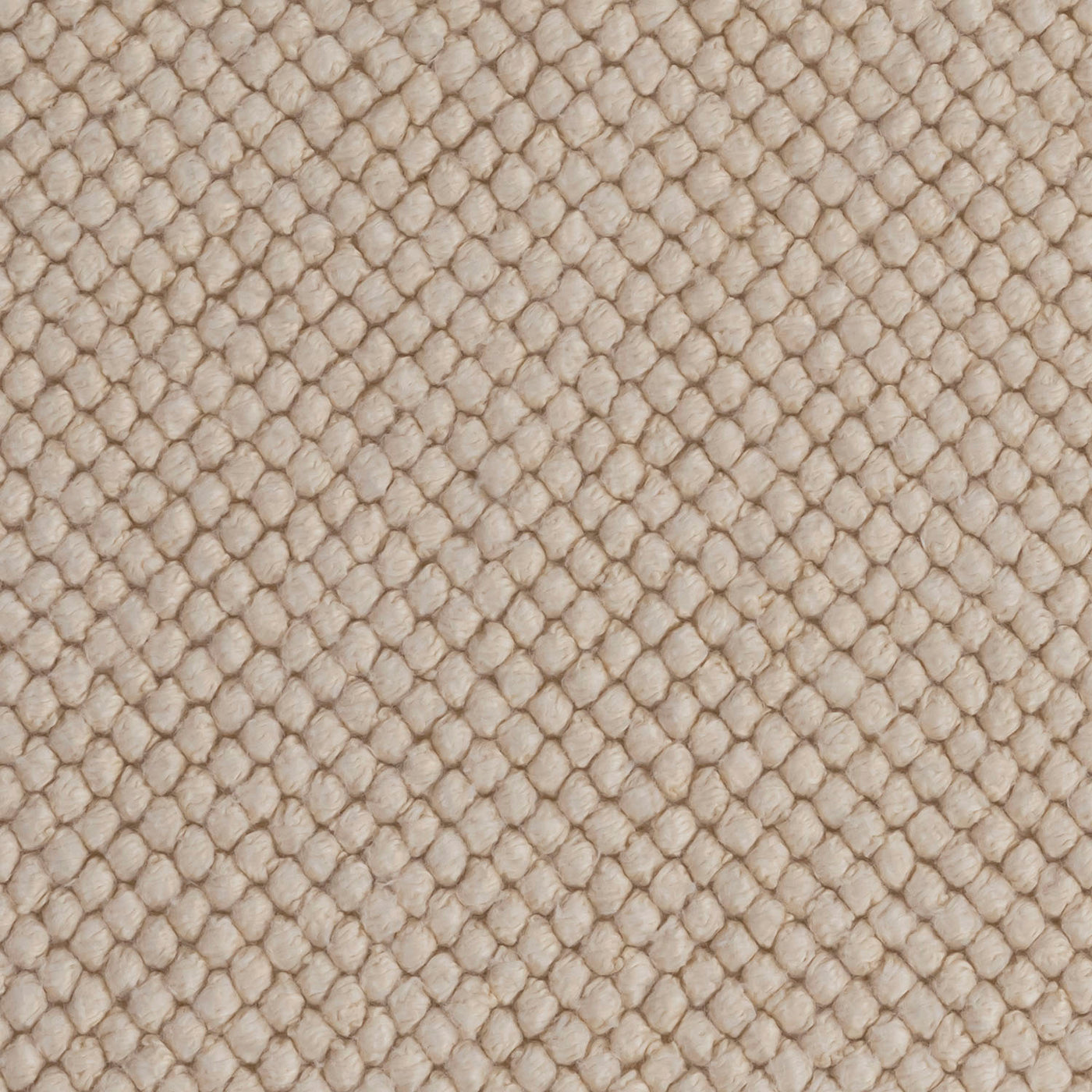 Close-up of Matouk Reverie bath rug in sand, showing honeycomb cotton weave texture.