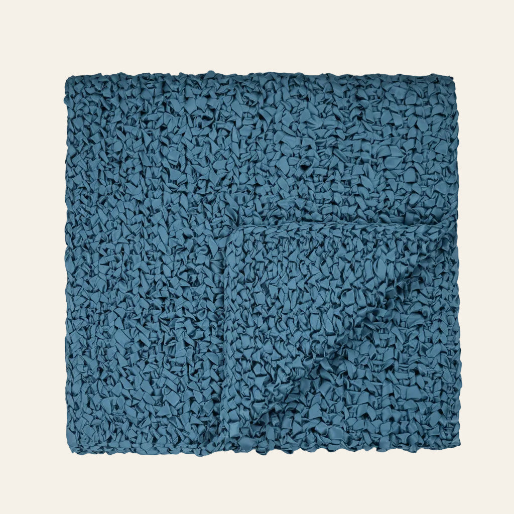 Ann Gish Ribbon knit throw in teal, folded to show chunky textured weave.