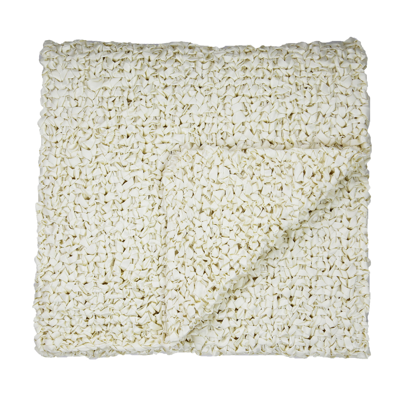 Close-up overhead view of ivory chunky open-knit ribbon throw, folded with corner turned back.