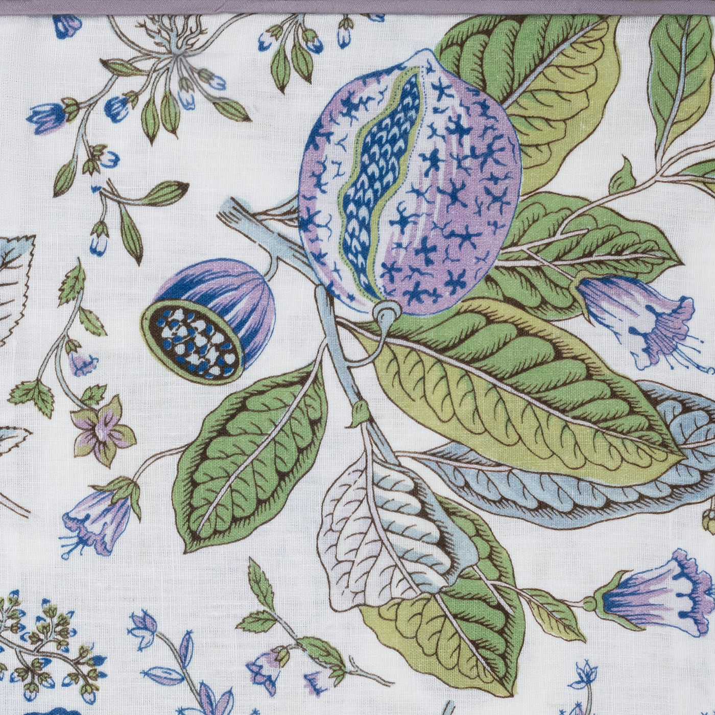 Matouk’s Roman Linen Pajama Set features floral pomegranate and lilac patterns with green leaves, purple-blue flowers, and a split fruit on white linen—ideal for chic, lightweight loungewear.