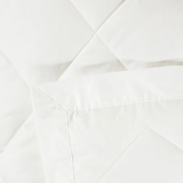 Close-up of white quilted stitching detail on Scandia Home down robe fabric.