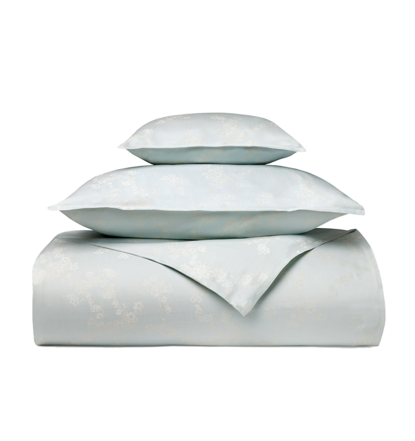 Sferra Salara duvet cover and pillowcases in folded stack, seafoam floral jacquard.
