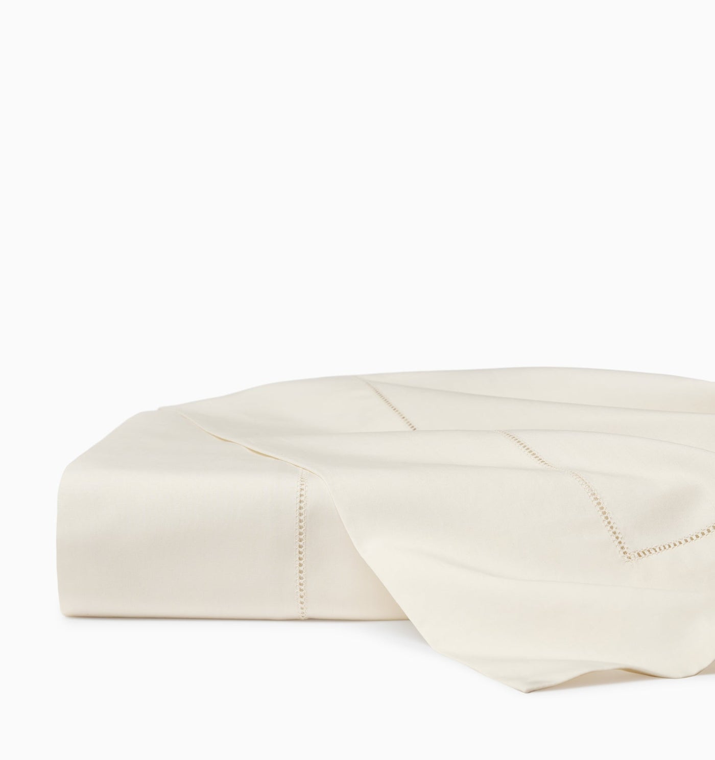 Ivory folded flat sheet with delicate hemstitch border detail along the edge.