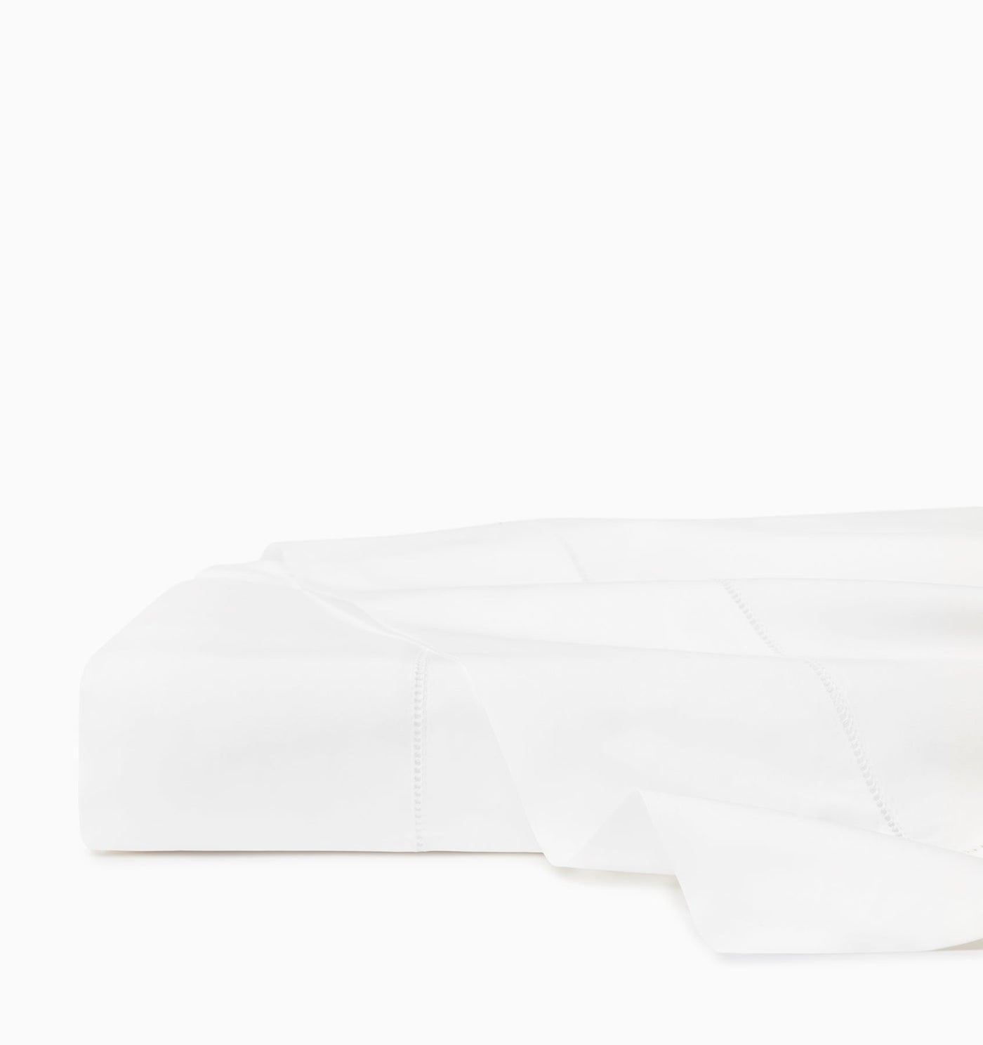 Folded white flat sheet showing hemstitch border detail along edge.