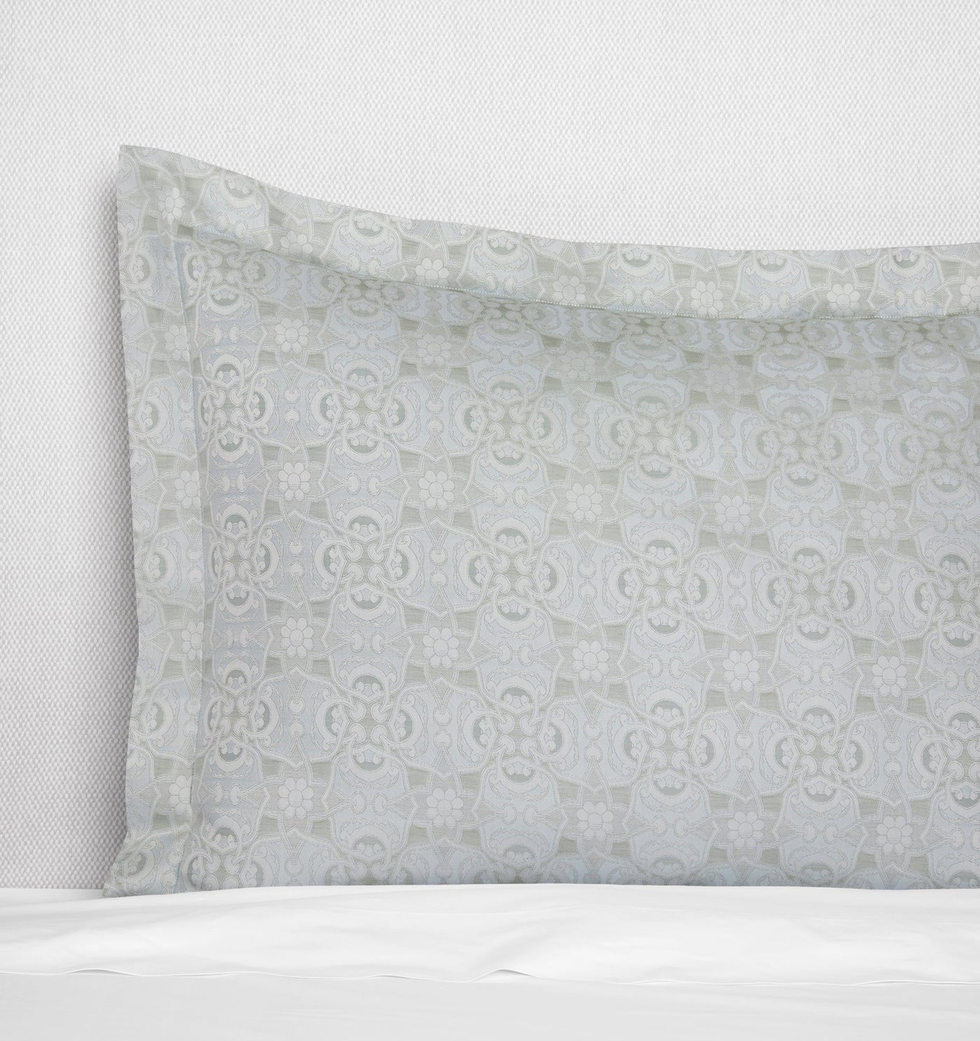 Close-up of Sferra Maiolica sham in silver-grey with tonal medallion jacquard pattern.
