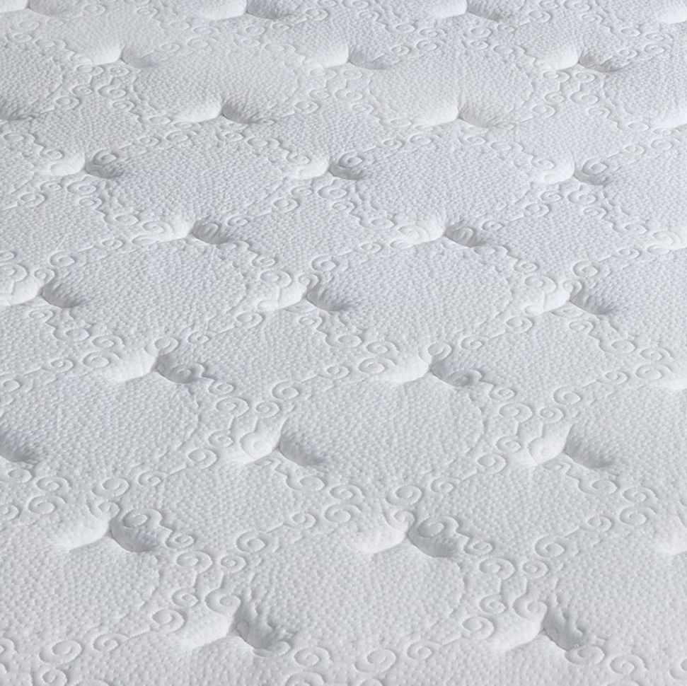 Close-up of a white quilted mattress or cushion surface with a repeating tufted pattern.