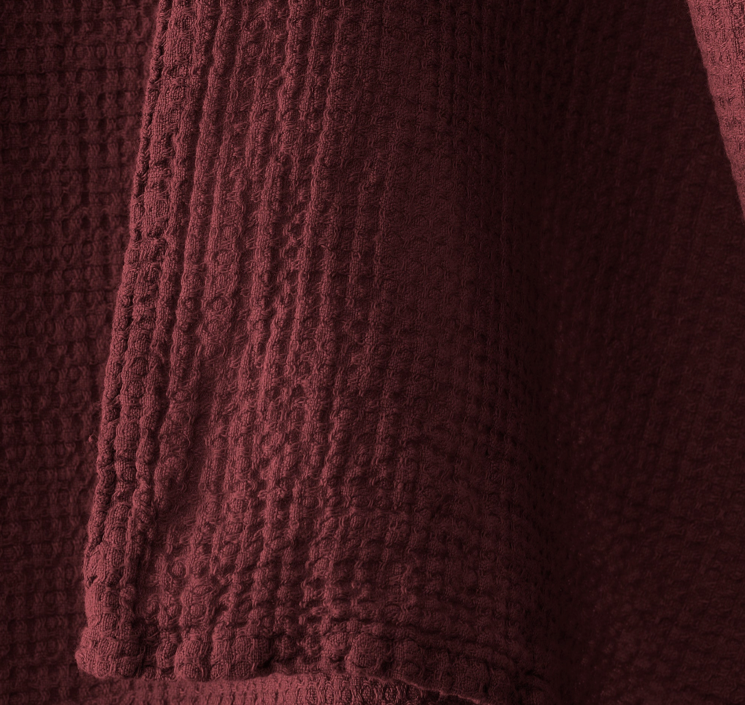 Close-up of Society Limonta Lipe New towel waffle texture in deep burgundy.