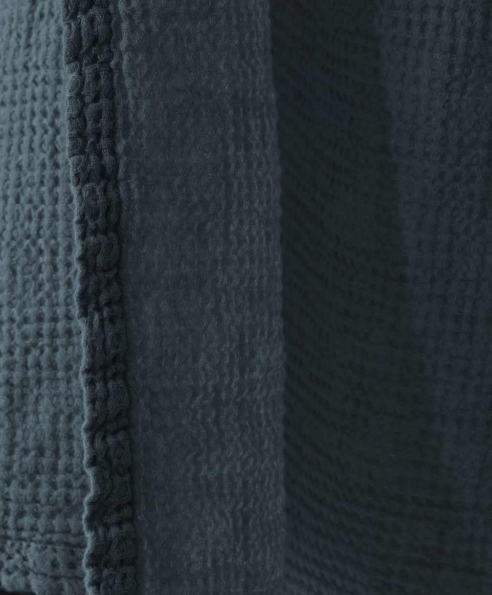 Close-up of slate waffle-weave texture and stitched edge detail on Society Limonta Lipe New towel.