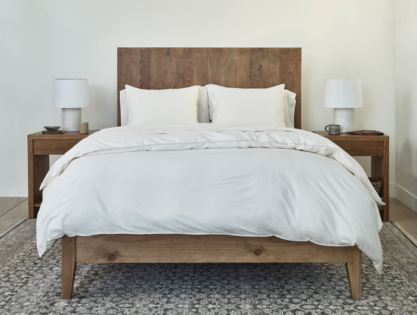 Ivory crinkled percale duvet cover styled on bed with rustic wood frame and neutral bedding.