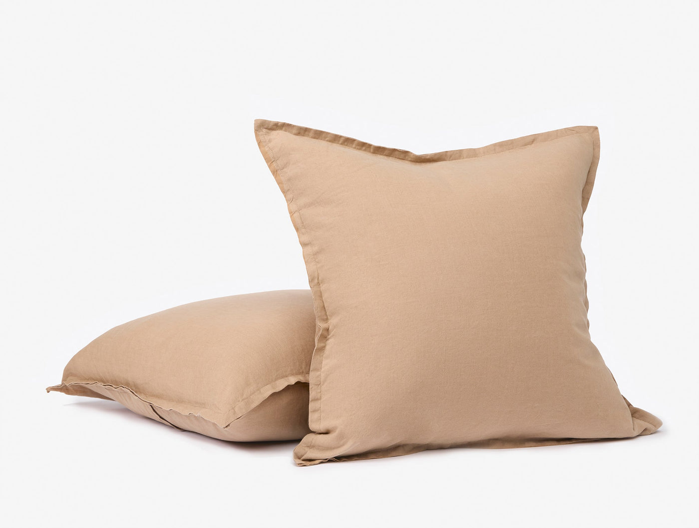 Two Coyuchi Relaxed Linen decorative pillows in warm sand, showing flanged edge detail.